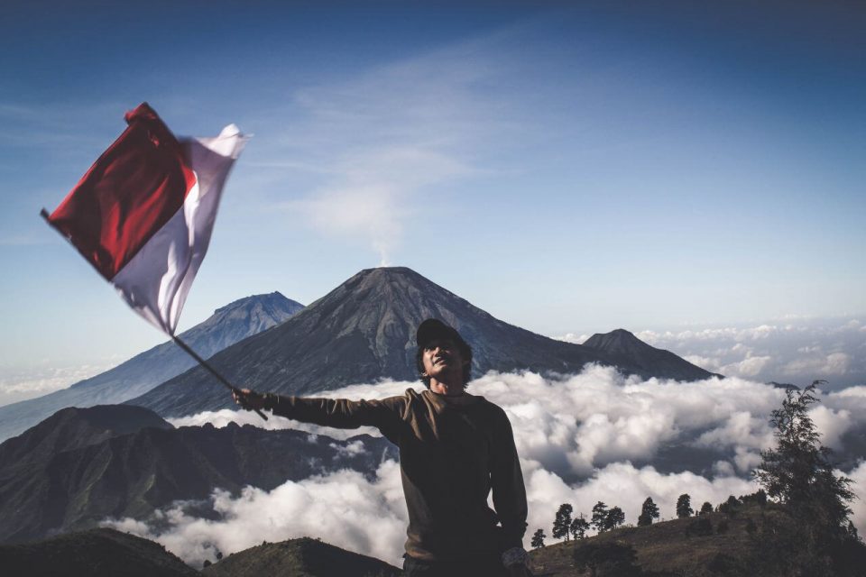 man holding indonesian flag